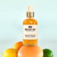 Apple Cider Mignonette Vitamin C Accelerator bottle on a grapefruit with lemon, orange and lime